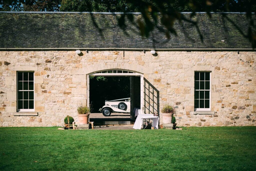 Kirknewton House Stables Weddings - Old car arrival